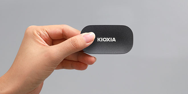 A hand holding a portable SSD